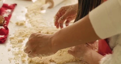 Handheld view of child using a cookie cutter while baking 動画素材 119318575