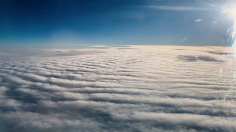 Handheld - View of clouds through airplane window. Cloud layer below Stock Footage 103269448