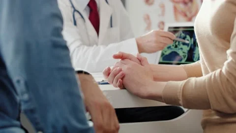Handheld view of couple at routine visit at their gynecologist. Stock Footage 144657438