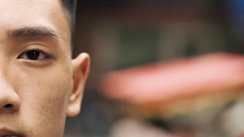 Handheld view of half the face of a Vietnamese man Stockbeeldmateriaal 126026394