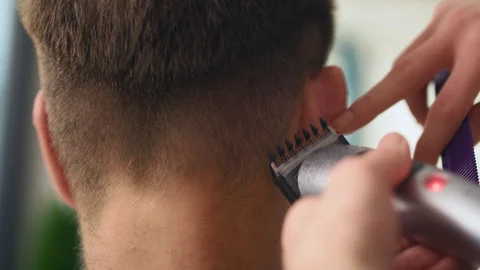 Handheld view of man has cutting hair at the hairdresser Stock-Footage 125067417