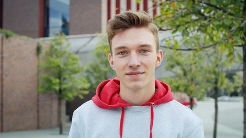 Handheld view of smiling young man looking at camera Stock Footage 125463585