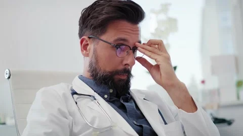 Handheld view of tired and stressed doctor in his office. Stock-Footage 145459541