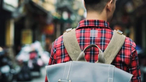 Handheld view of tourist with backpack walking in Vietnamese street Stock-Footage 126026856
