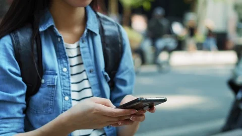 Handheld view of tourist using mobile phone in town Stockbeeldmateriaal 125080639