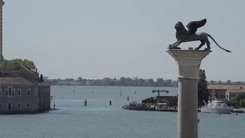 Handheld view of Venice boat dock watching the river, Lion Statue foreground Stock Footage 79824002