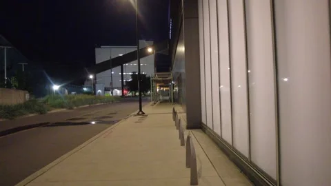 Handheld walking POV along an empty night sidewalk in Toronto Stock Footage 345996086