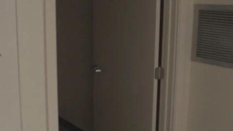 Handheld walking through doorway into darkness Stock Footage 252289673