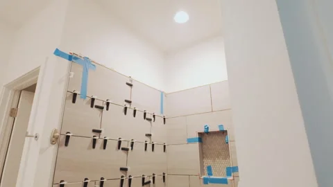 Handheld Walkthrough Reveals Unfinished Tiled Shower Installation 스톡 동영상 344973734