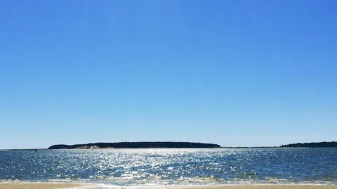 Handheld Wide - Beach Tilt Down from Sun Stock Footage 92760076