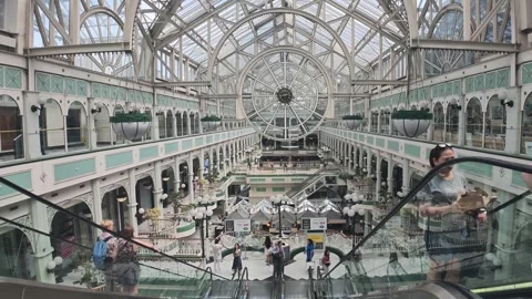 Handheld wide video of a clock face in St. Stephen's Green Shopping Centre with Stock Footage 340040025