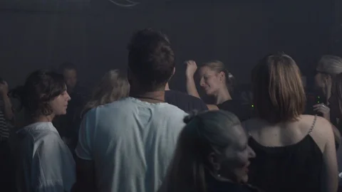 Handheld of young people dancing on night party in night club Stock Footage 114877173