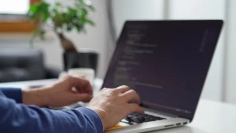 Handhled closeup of programmer writing code using laptop Stock Footage 162468165