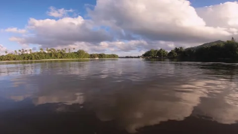 Handhold low angle still view from above surface of water look out to islet of t Stock Footage 253463142