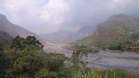 Handhold still view over look out to terrain horizon down to riverbed and small  Stock Footage 266503312
