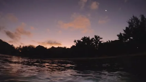 Handhold view on the surface of ocean water at the Avana harbor with torch flash Stock Footage 259465348