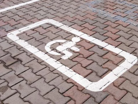 Handicap parking space symbol on paved surface Stock Photos