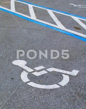Handicap Synbol on asphalt in a parking lot Stock Photos