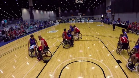 Handicapped and disabled veteran soldiers compete in wheelchair basketball in Stock Footage
