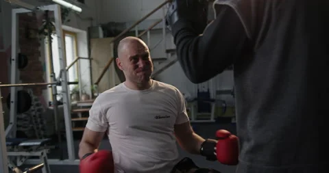 Handicapped boxer practicing with trainer in gym Stock Footage 154297315