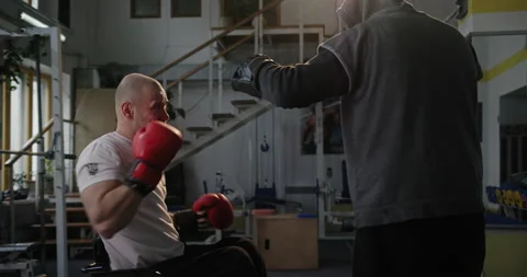 Handicapped boxer sparring with trainer Stock Footage 154714724
