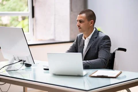 Handicapped Businessman Using Laptop Computer Stock Photos