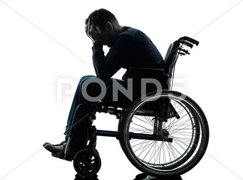 Handicapped man head in hands in wheelchair silhouette Stock Photos