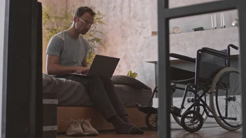 Handicapped Man Using Computer on Bed Stock Footage 158229369