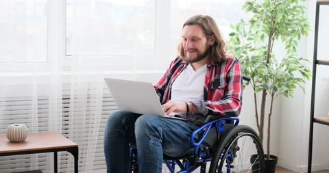 Handicapped man video conferencing using laptop in wheelchair Stock Footage 149097166