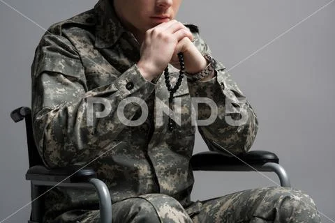 Handicapped military young male praying Stock Photos