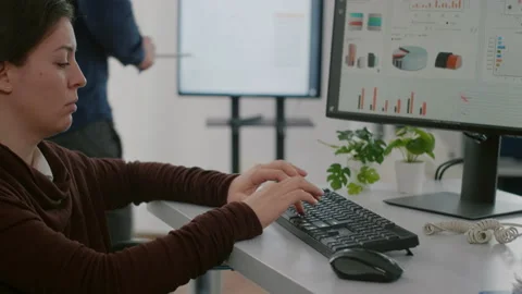 Handicapped worker analysing financial statistics typing on computer Stock Footage 154395232