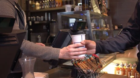 Handing coffee cup to customer in small coffee shop. 4k Stock Footage 124675643