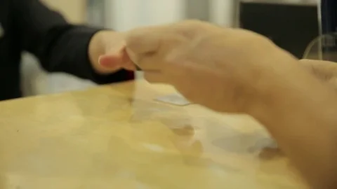 Handing ID card over counter Видео 77051978