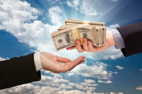 Handing Over Cash with Dramatic Clouds and Sky Background. Stock Photos