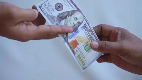 Handing over a one hundred dollar bill, as payment for services or purchase Stock Footage 322159665
