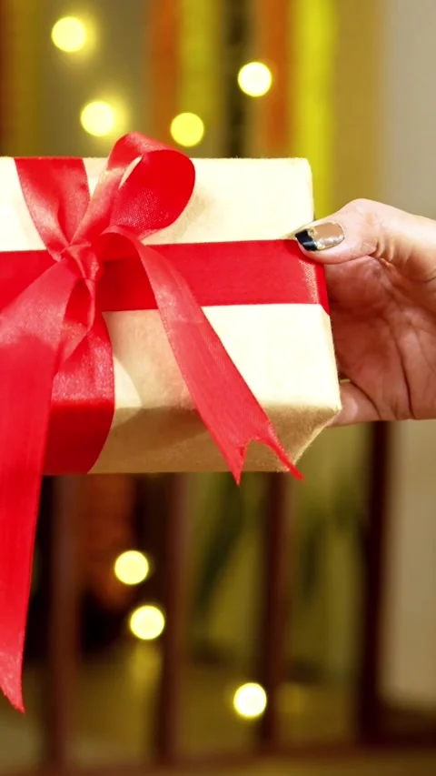 Handing Over Wrapped Gift Box During Diwali Festival with Soft Bokeh Stock Footage 342381314