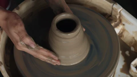 Handiwork master behind potters wheel with earthen jar Stock Footage 311945157