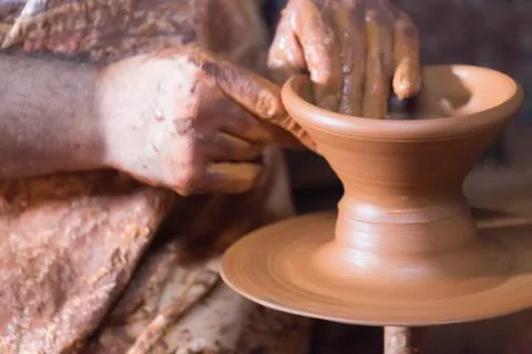 Handiwork pottery making on pottery wheel. Stock Photos