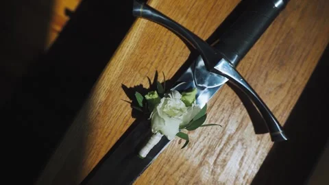 Handle of an ancient medieval sword, rapier, knife, blade with a white rose on Stock Footage 312768190