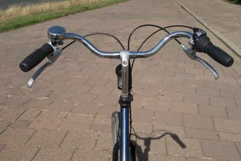 Handle bar on a bicycle seen from the point of view of the cyclist with stree Photos