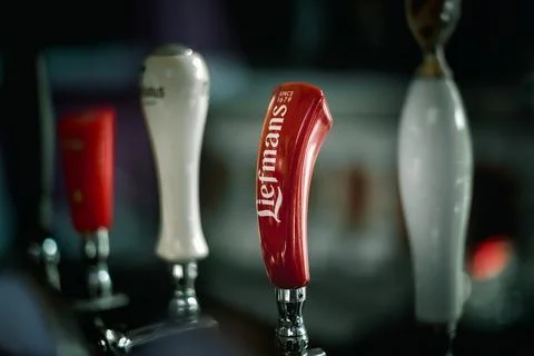 Handle of draft beer on bar counter Stock Photos