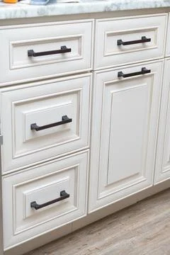 Handle installation drawers in custom kitchen cabinets Stock Photos