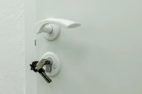 Handle, lock, lock keys and white door Stock Photos
