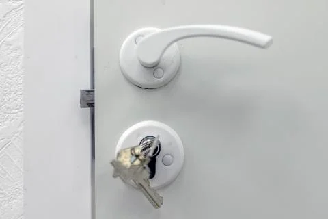 Handle, lock, lock keys and white door 스톡 사진