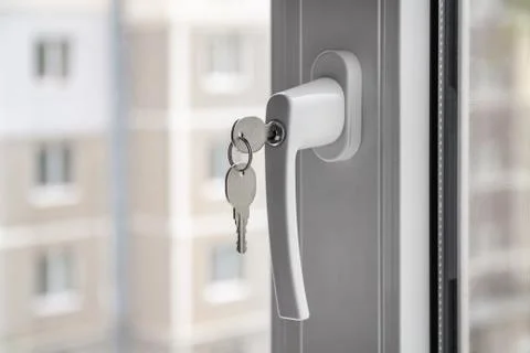 Handle with a lock on the window. Stock Photos