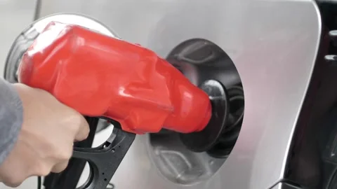 Handle of refueling gun. Insert red gun into tank of car for refueling The Stock Footage 256723334