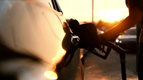 Handle of refueling gun. Insert red gun into tank of car for refueling The Stock Footage 256723656