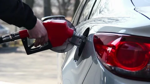 Handle of refueling gun. Insert red gun into tank of car for refueling The Stock Footage 256723717