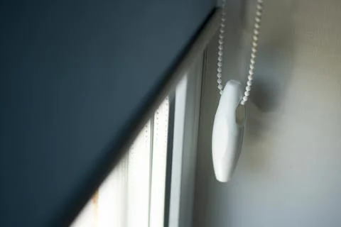 Handle for roller up down blinds on a metal-plastic window. Stock Photos