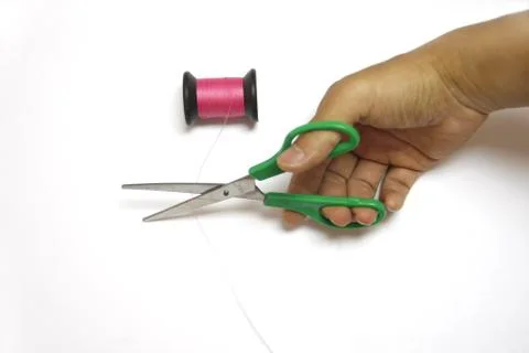 Handle scissors cuting pink sewing thread Stock Photos